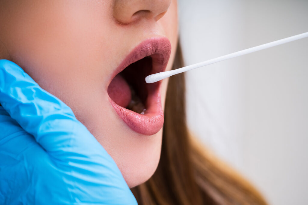 Close-up Of A Doctor Taking Saliva Sample For DNA Test